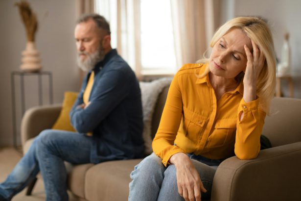 Unhappy Senior Couple After Quarrel Sitting On Sofa At Home